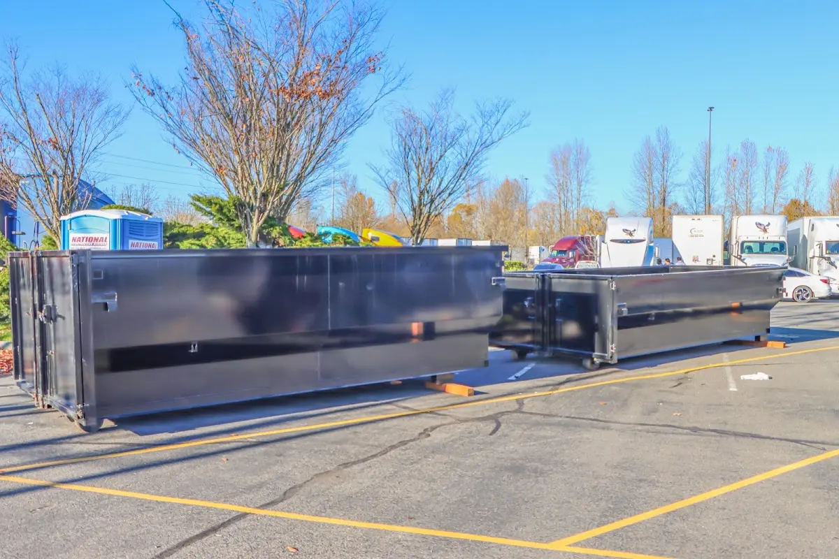 Professional dumpster rental service with roll-off container on residential driveway in Winder